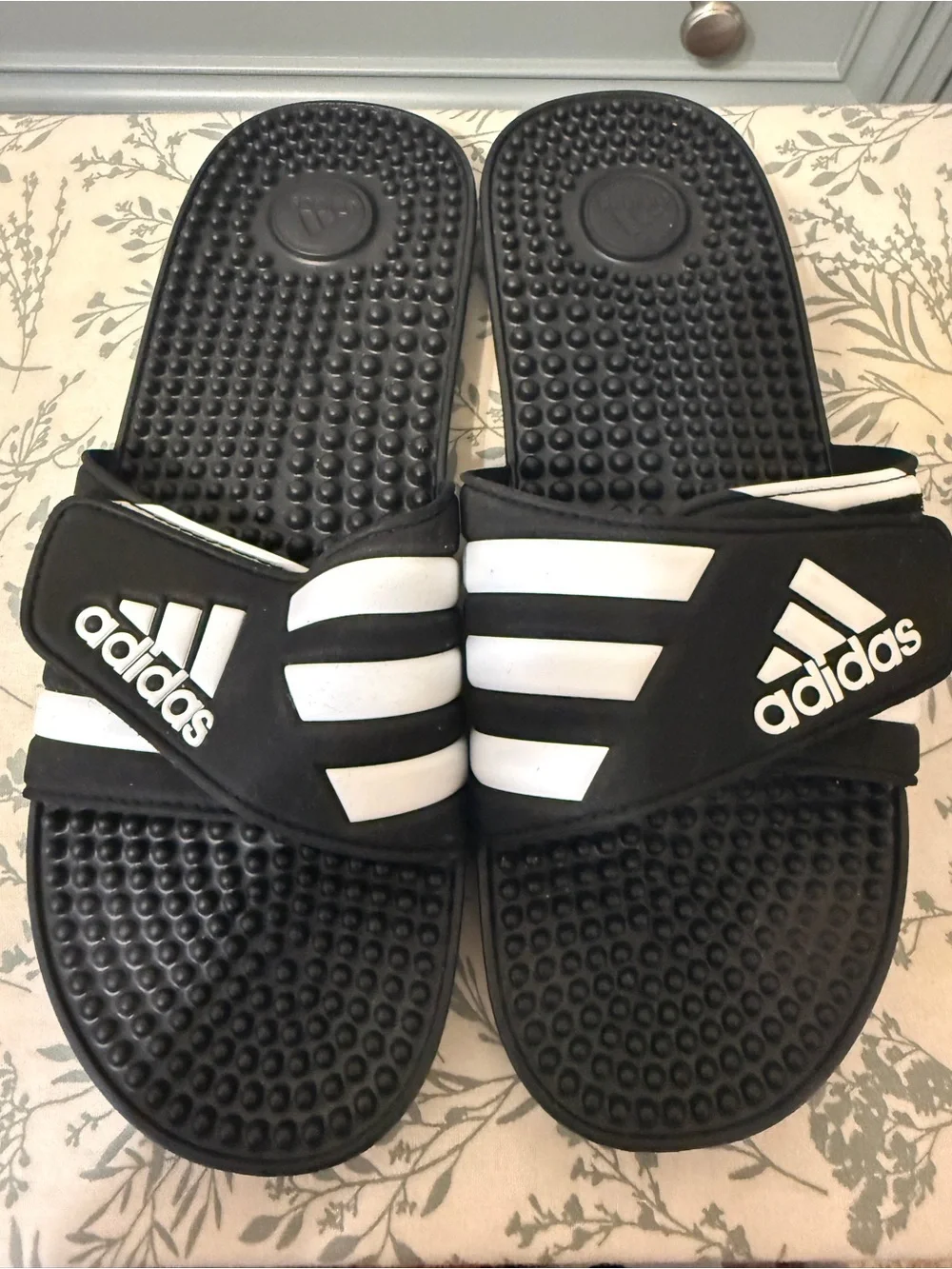 Adidas Adissage massage slides in classic black and white.
